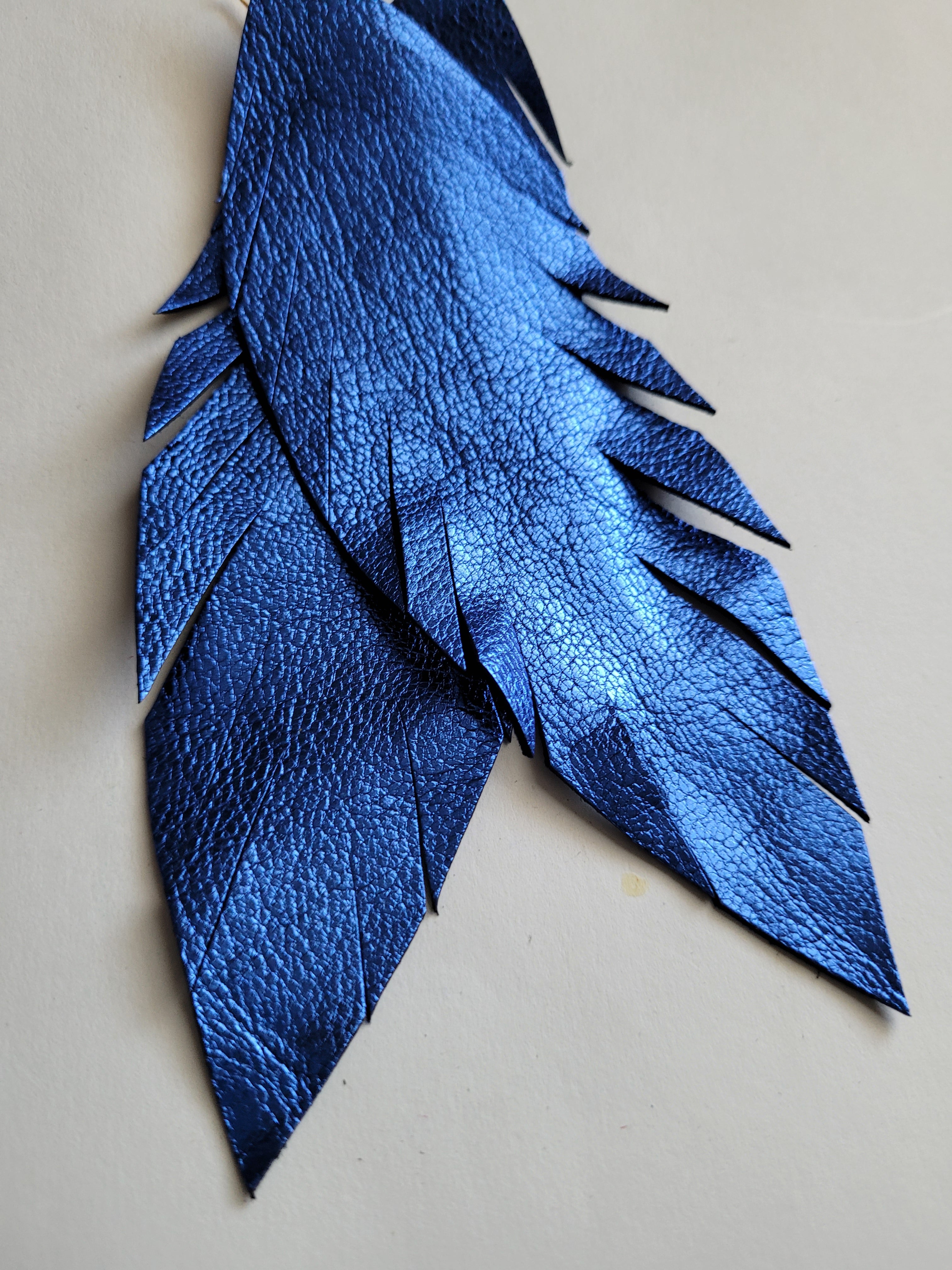 "Aw, S$%t" Metallic Blue Leather Feather Earrings